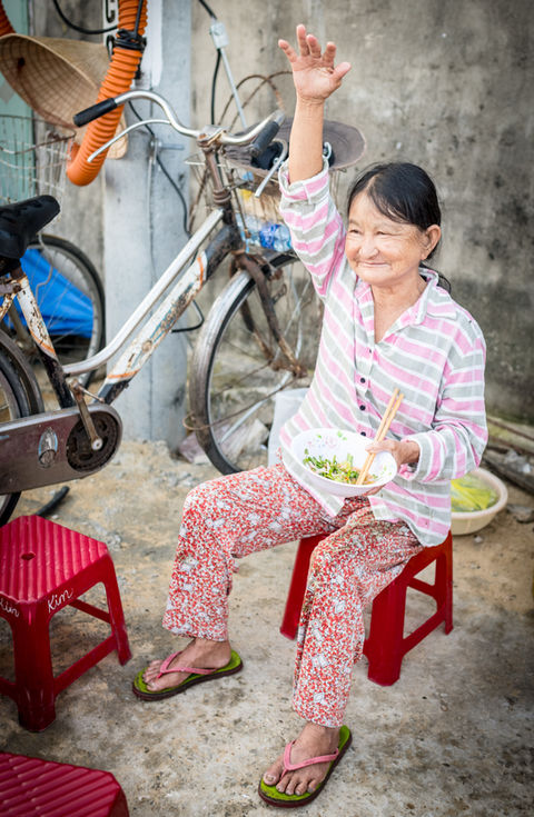 A woman waving hello