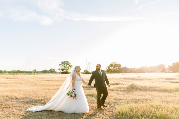 Bride and groom in open field wedding venue near  me