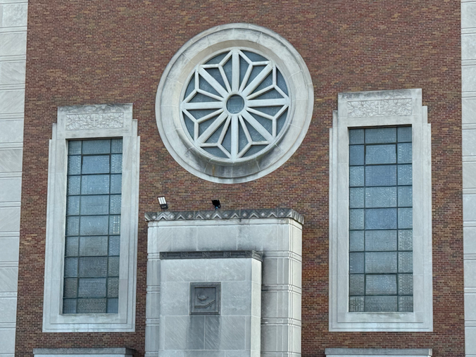Circular window between two columns; building exterior; Joliet, Illinois