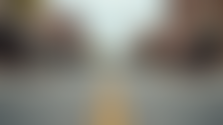 Eye-level view of a freshly paved street in downtown Harlan with new benches and street lamps