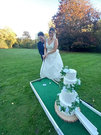Bride & Groom playing crazy golf at wedding