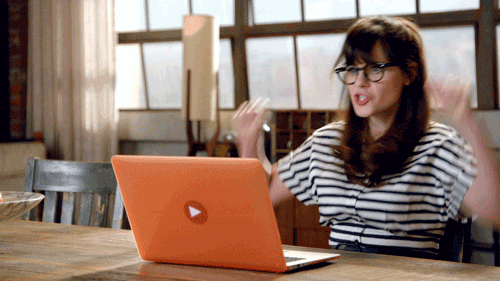 The gif is of Jess Day from New Girl excitedly pumping her arms while looking at an orange laptop.