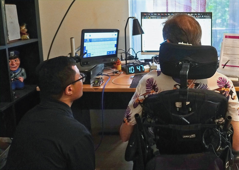 Bryan working with a client to ensure that his device is working for him
