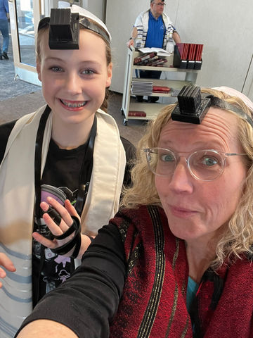 Two women in tallit and tefillin