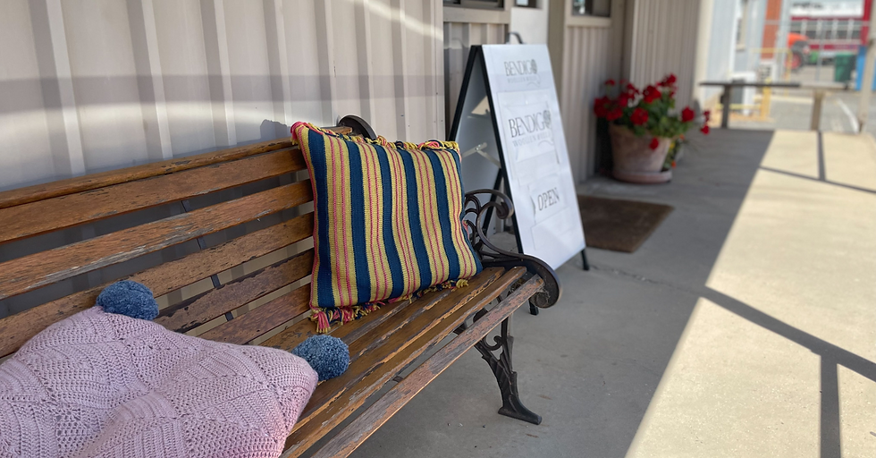 bench seat with cushions under a porch