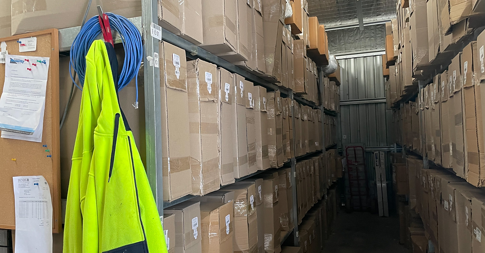 a corridor of stacked boxes in a warehouse