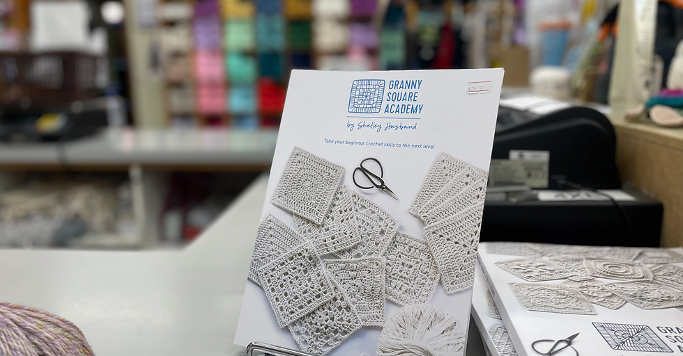crochet book on a stand at a sales counter