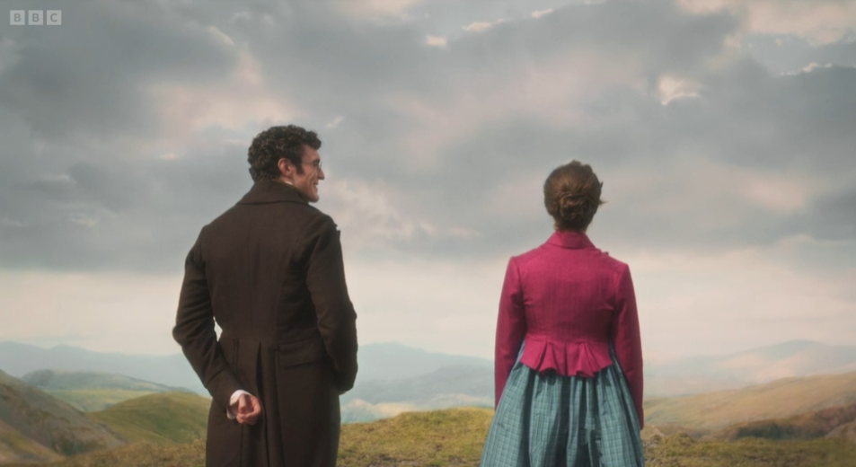 BBC logo. A man and woman in period dress stand on a grassy hill, looking over misty mountains under cloudy sky.