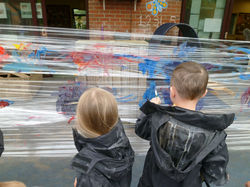 Children painting on clingfilm