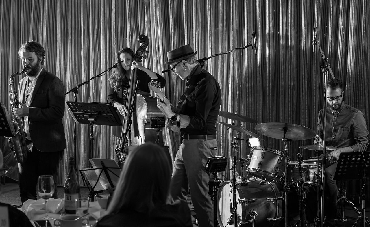 jazz band playing saxaphone, guitar, drums and double bass