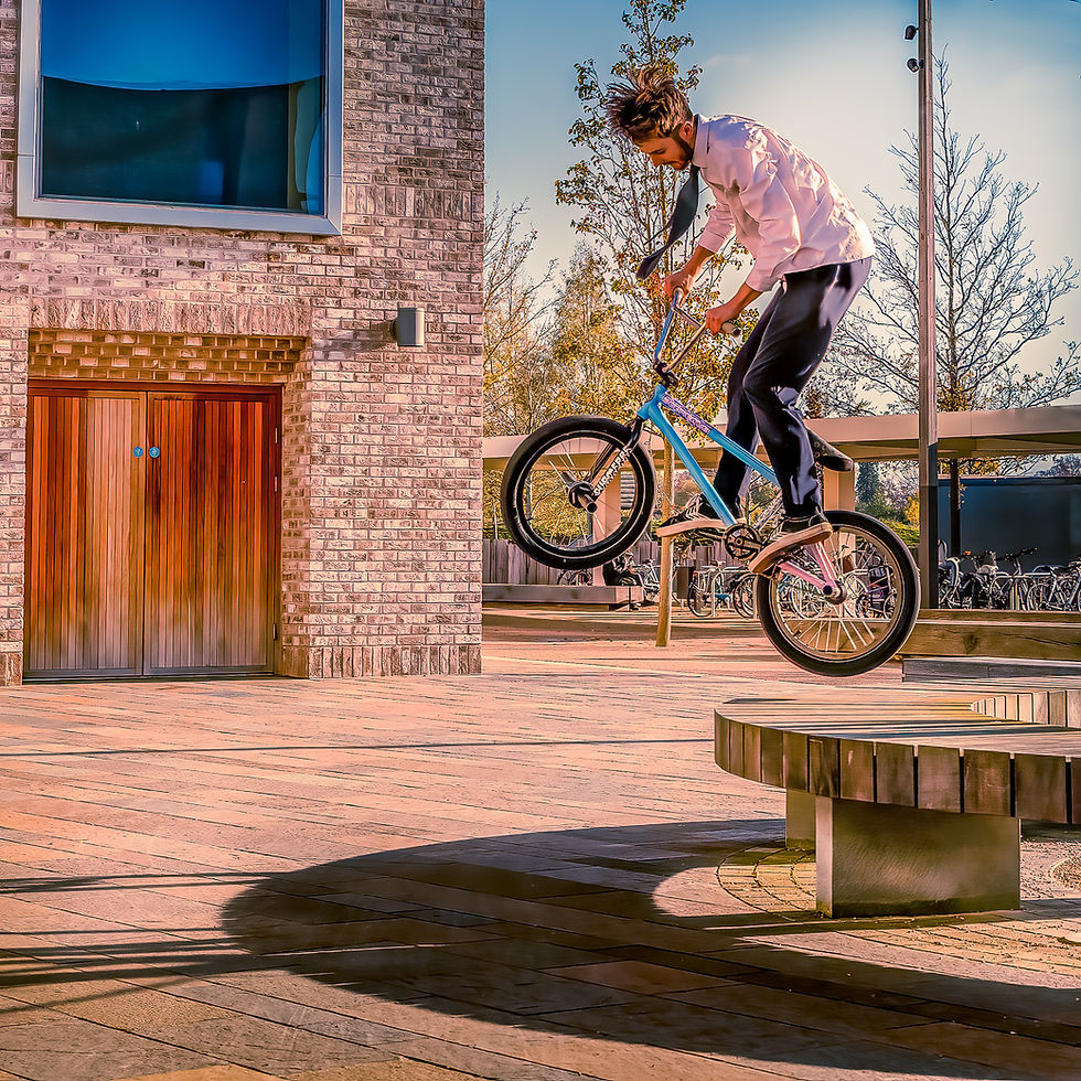 BMX rider performing a trick, photographed mid air