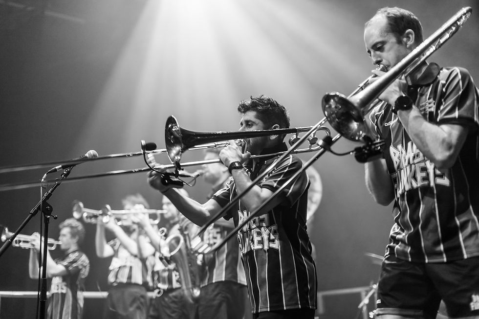 musicians in a line playing brass instruments
