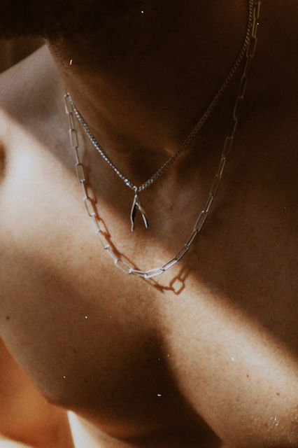 Handcrafted silver necklace with minimalistic organic shape, unisex Scandinavian jewelry, layered silver chain made in Stockholm, modern handcrafted pendant.