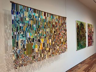 colorful artwork hangs on a blank wall