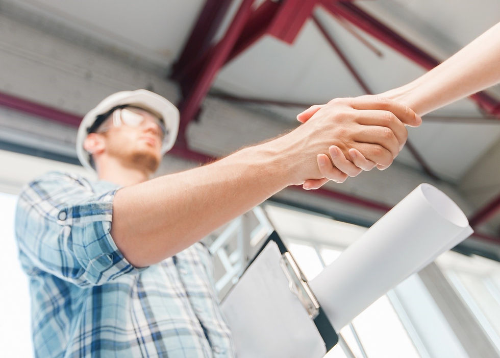 A home renovation contractor shaking hands with a client.