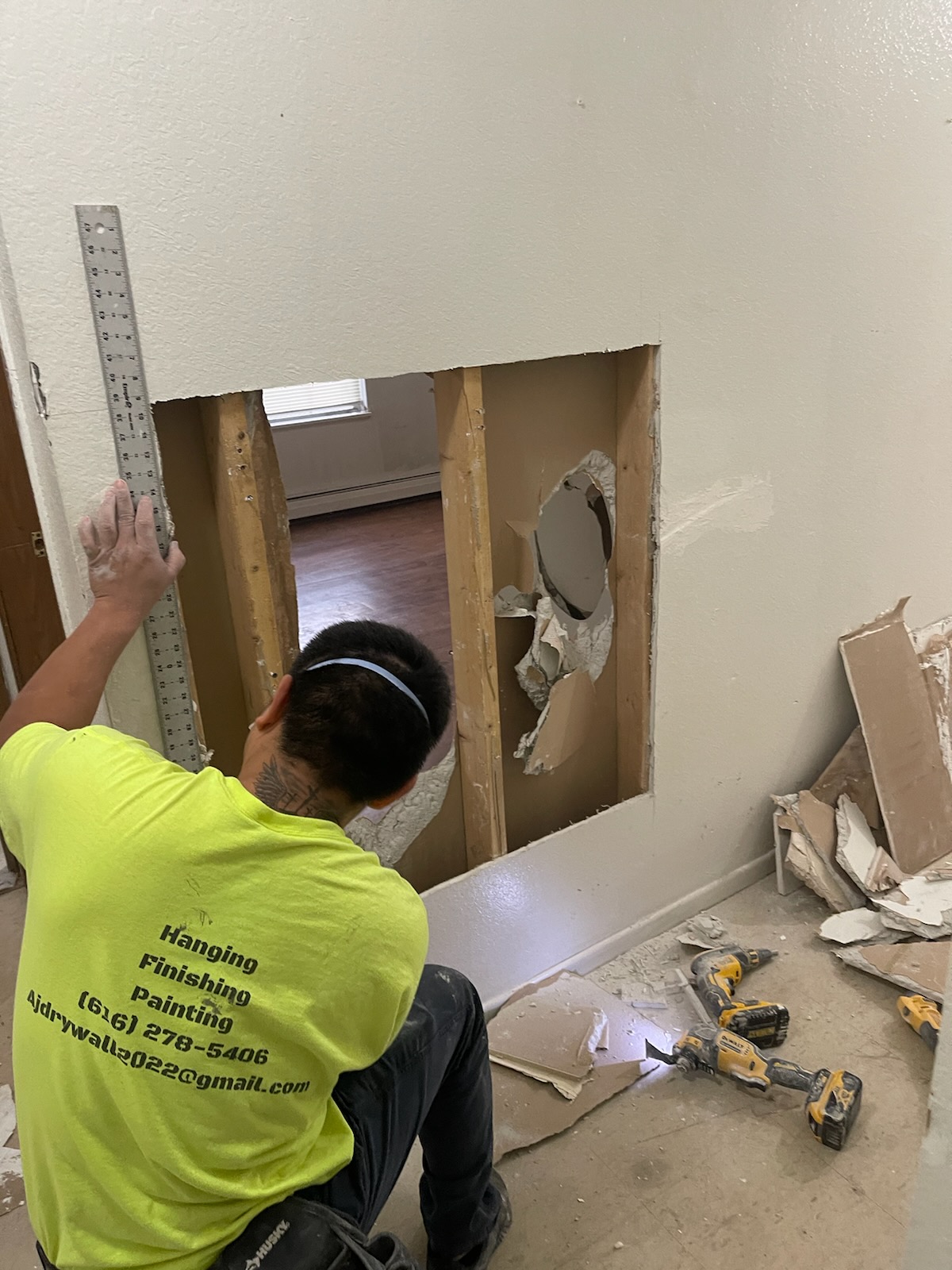 AJ Drywall repairing an opened wall