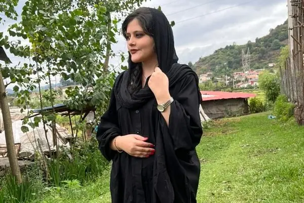 Iranian women in a black headscarf looks into the distance