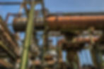 low-angle-shot-metal-structures-pipes-with-clear-sky.jpg
