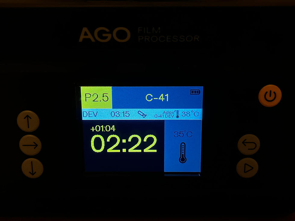 The interface screen of the AGO Film Processor compensating for temperature in action, showing an additional 1m 4s being added to the development time since the temperature has dropped.