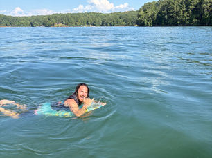 A man floats on his surf board on a lake