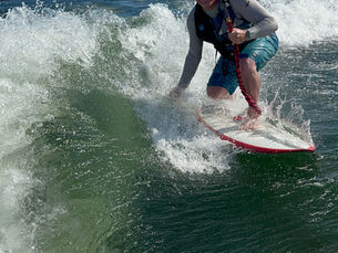 A man wake surfing behind a boat on Lake Allatoona