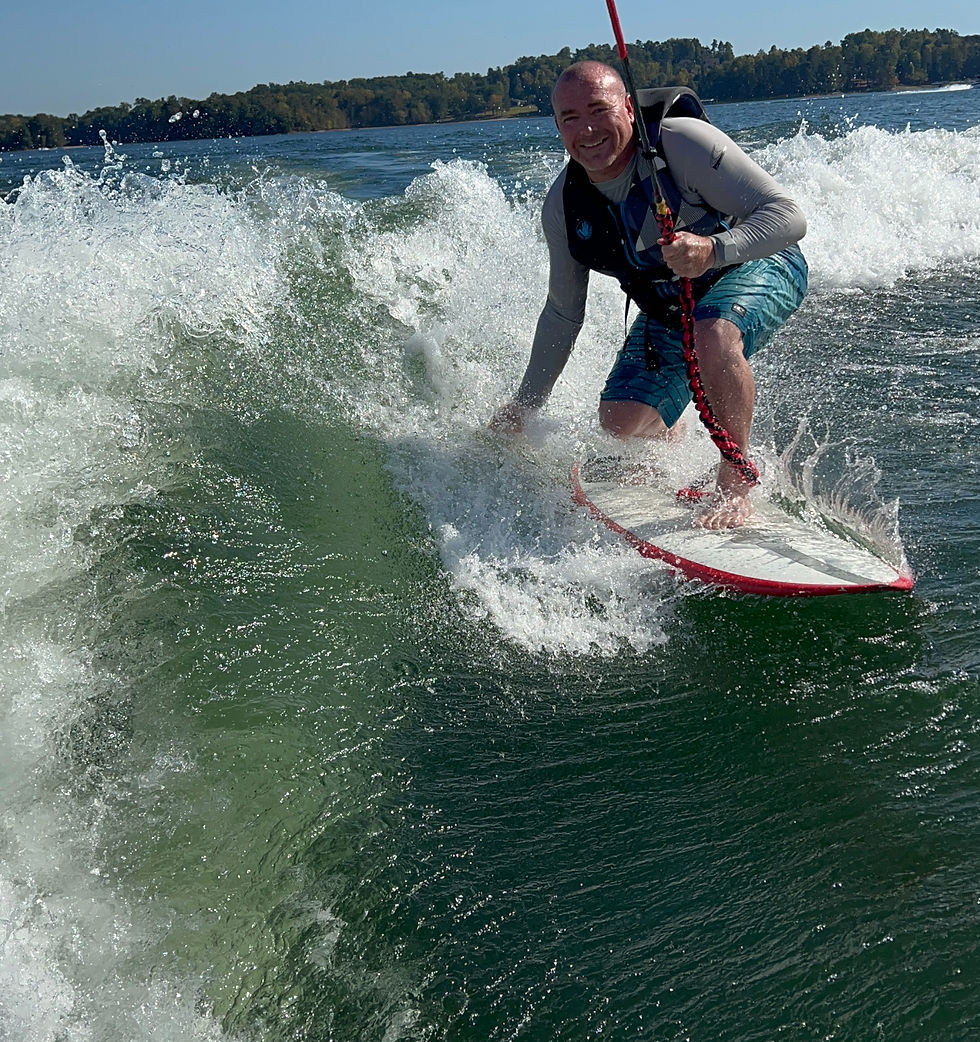 A man wake surfs behind the boat on Lake Allatoona after surfing the ocean for years