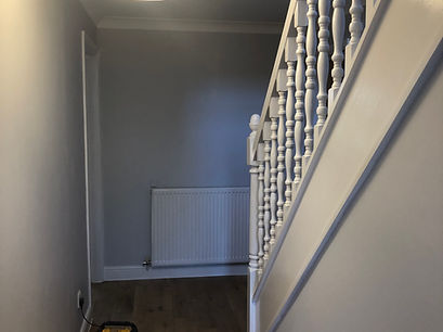 Hallway with stairs and freshly painted walls. Adam’s Painting & Decorating in Newbury
