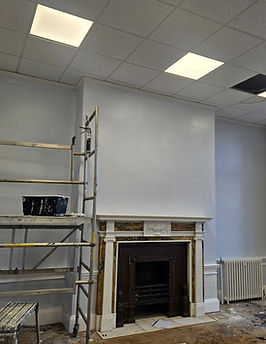 Room being decorated, scaffolding and fireplace; Newbury painter.