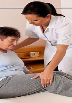 a female nurse caring/Supporting a female paralysis patient.