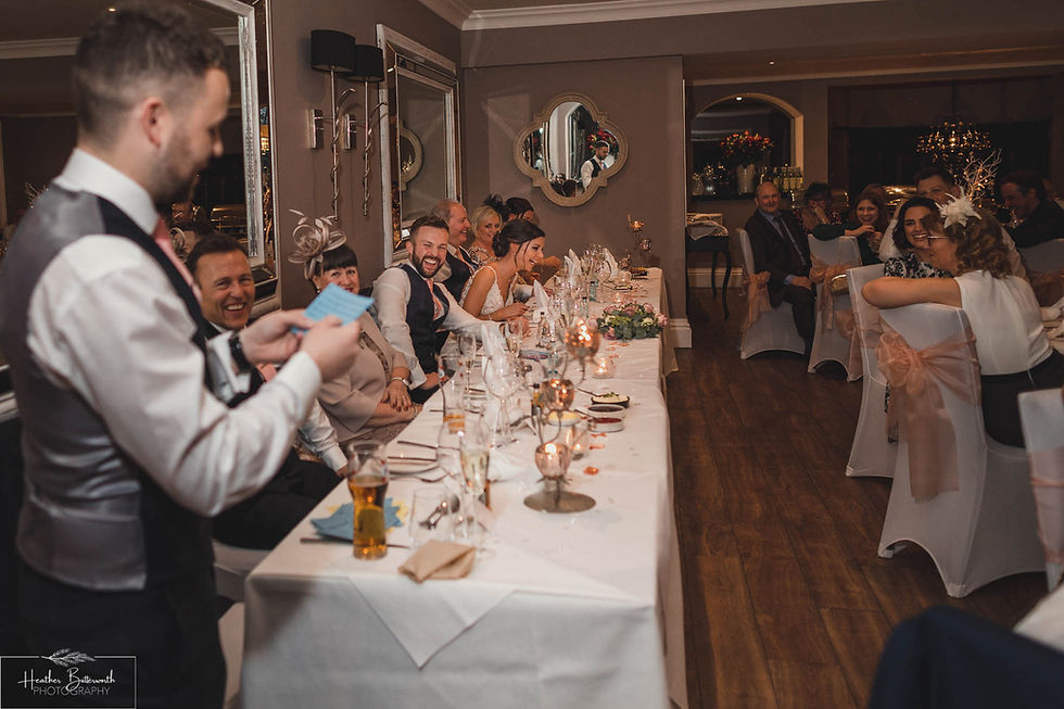 Bride and groom laughing during the speeches at The Burnside Hotel and Spa in Bowness-on-Windermere