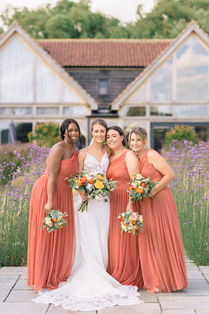 A bride in a white wedding dress with her bridesmaids at The Oakwood at Ryther in York Yorkshire