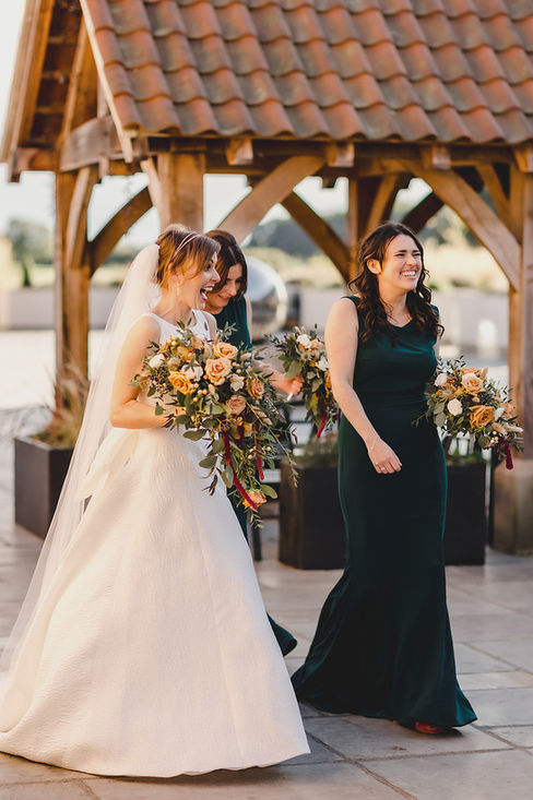 A bride laughing with her bridesmaids at The Oakwood at Ryther near Leeds in Yorkshire
