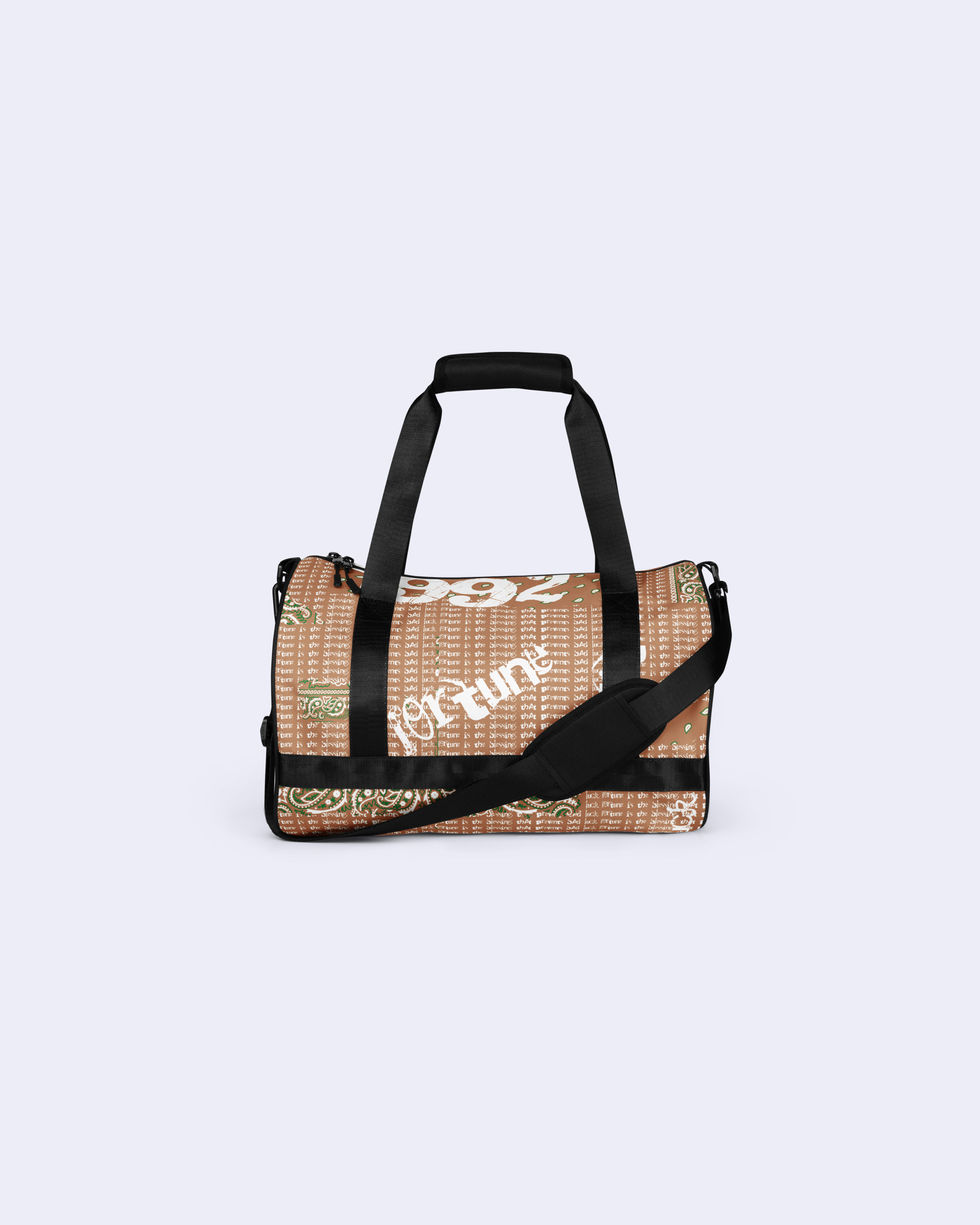 Brown woven duffle bag with "fortune" and "1992" text, black handles.