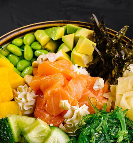 Salmon poke bowl with avocado, edamame, and seaweed