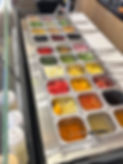 Fresh salad bar with various vegetables and dressings