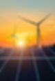Wind turbines and solar panels at sunset. renewable energy concept