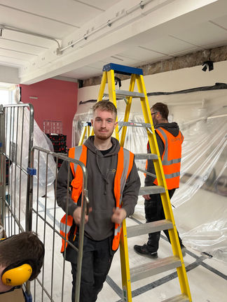 two electricians using ladders
