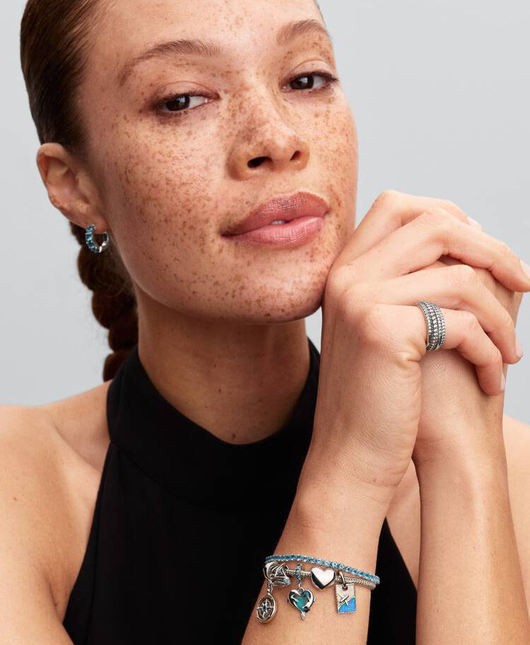 Woman wearing jewelry, rings, and bracelets; Pandora Elevated Black Heart Ring, Jewels by the Sea.