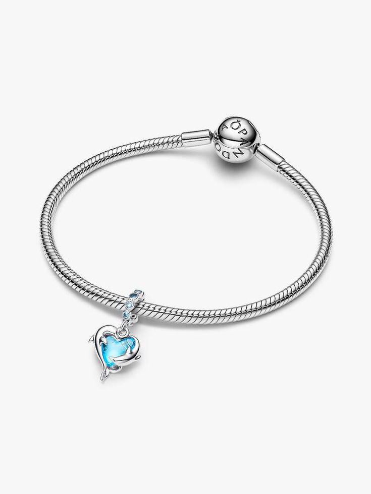 A silver bracelet with Pandora Blue Murano Glass Dolphins Dangle Charm on display.