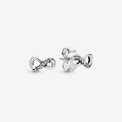 Silver infinity stud earrings with sparkling crystals, elegant design, jewelry detail.
