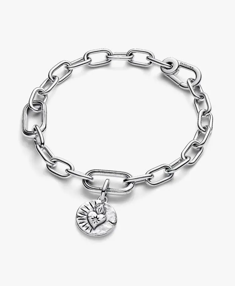 Silver bracelet with a pendant featuring a heart design; Jewels by the Sea.