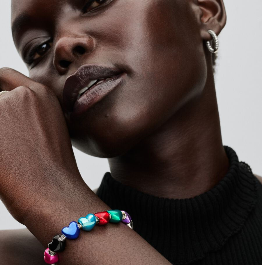 Woman with bracelet featuring colorful hearts, Jewels by the Sea.
