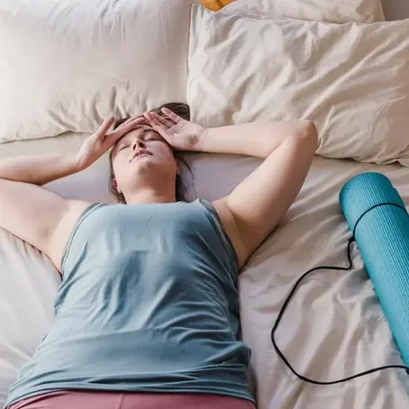 Woman laying on bed, worn out