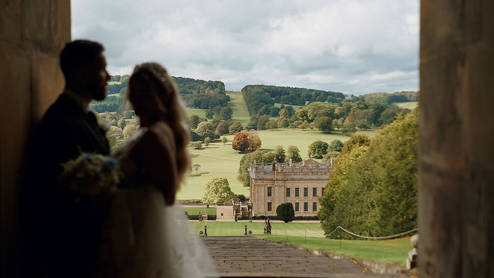 Eye-level view of Chatsworth House's grand entrance with autumn foliage