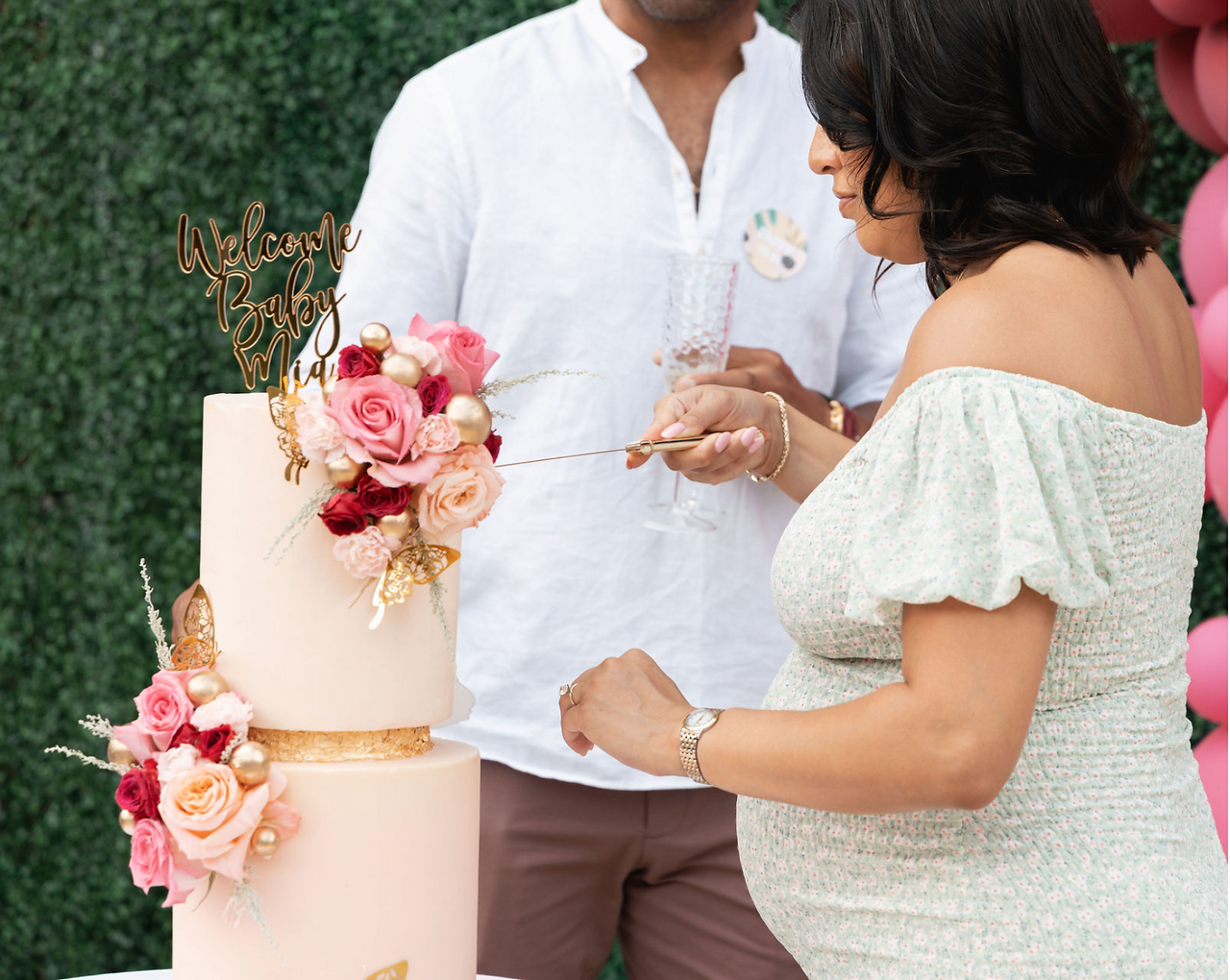 Mom-to-be cutting cake
