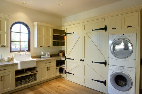 Custom white laundry cabinetry with unique design accents, Naples.