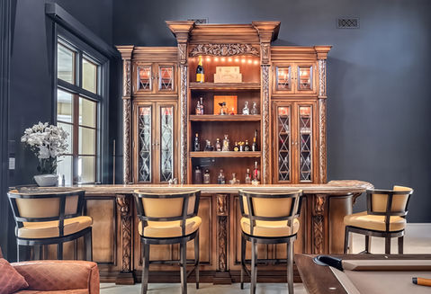 Custom carved old-world bar for luxury Naples estate.