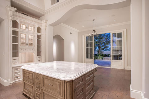 Grand white custom kitchen design in Naples estate residence.