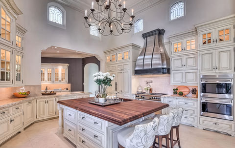 White estate kitchen with walnut island and custom metal hood in Paradise Valley.
