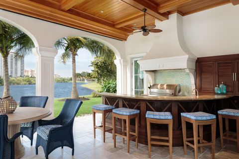 Outdoor cypress kitchen with louver doors and rounded bar front, Naples.